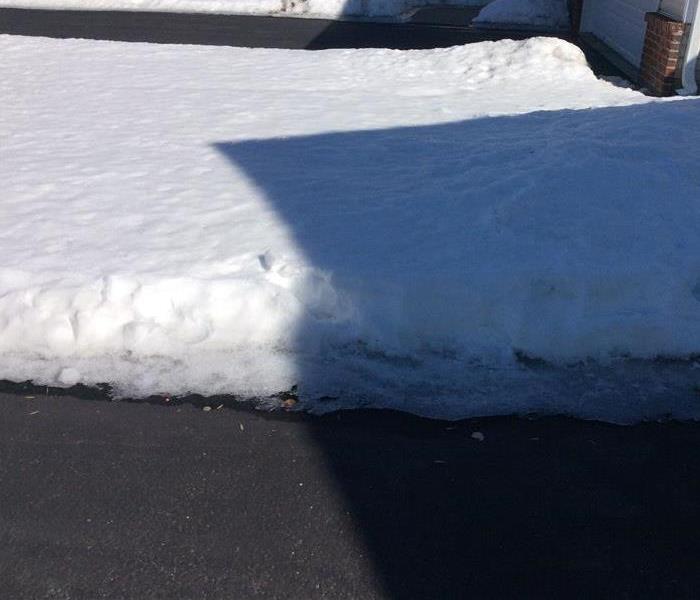 Snow pile on a concrete driveway