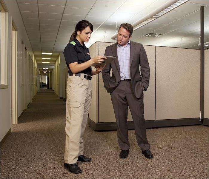 business man in office talking to female SERVPRO rep