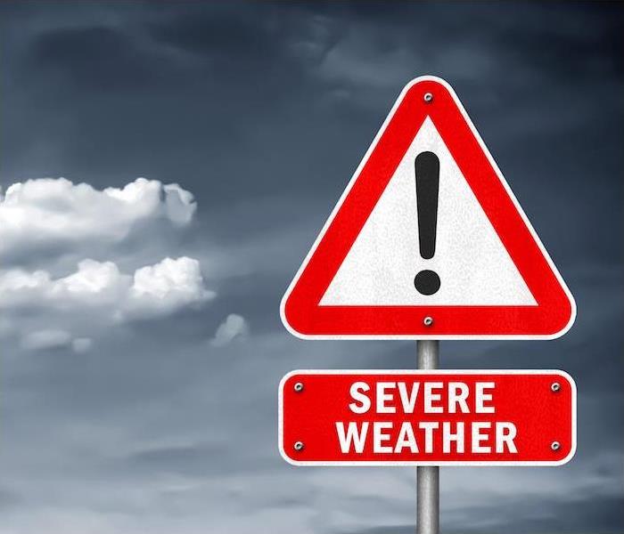 severe weather red sign with dark cloudy sky in background